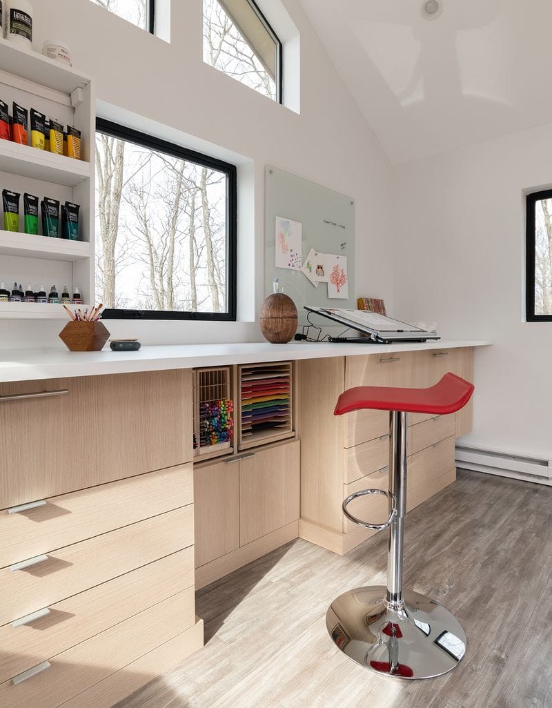 Studio design for a craft artist with custom shelving, drawers and desk by California Closets