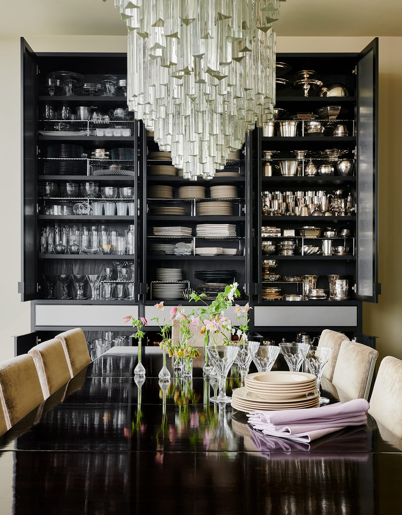 Kevin Sharkey's grand dining room with custom built shelving and drawers holding dinner and glassware created by California Closets