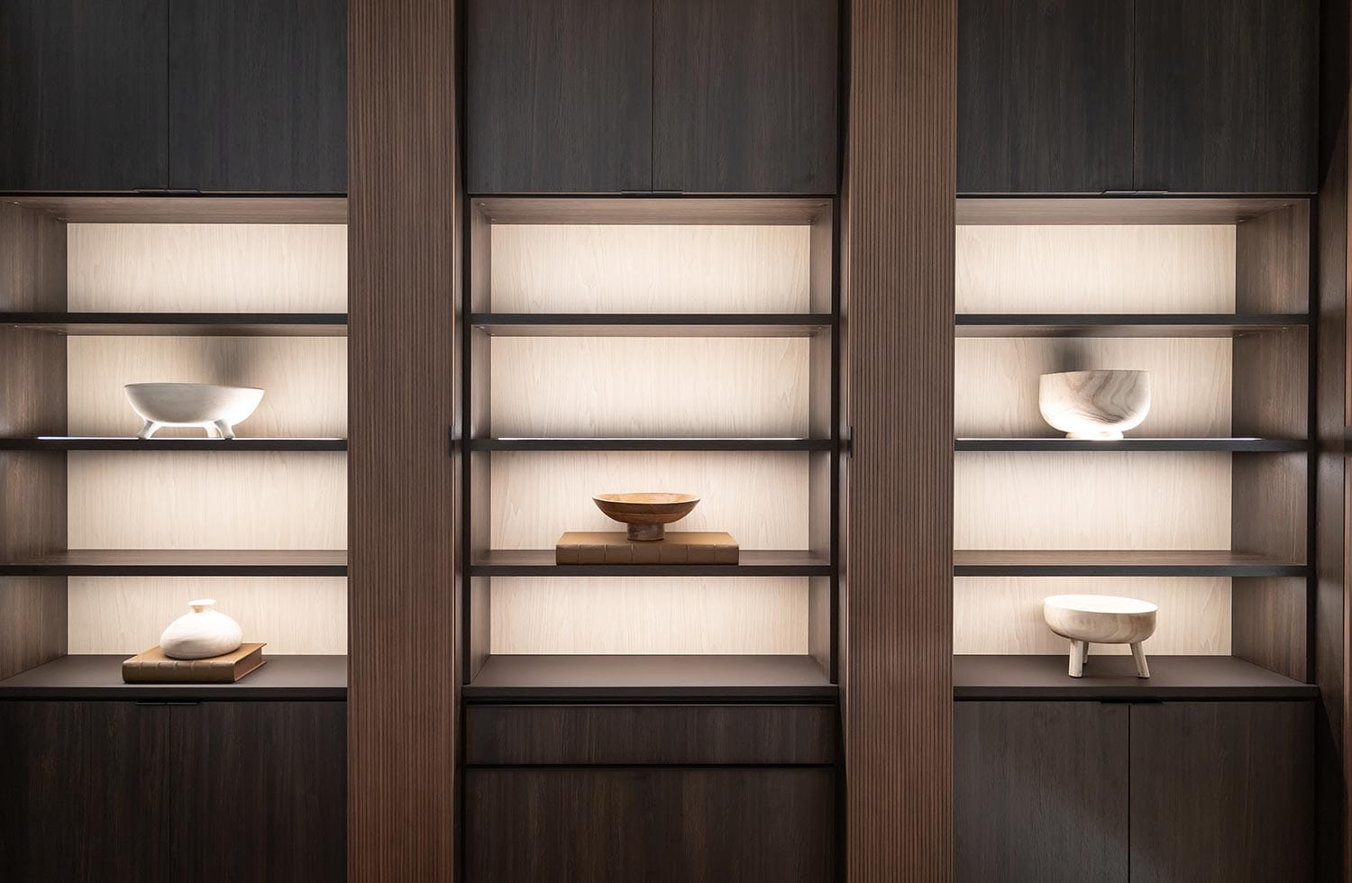 Custom closet shelving in a dark wood finish for home storage design by California Closets