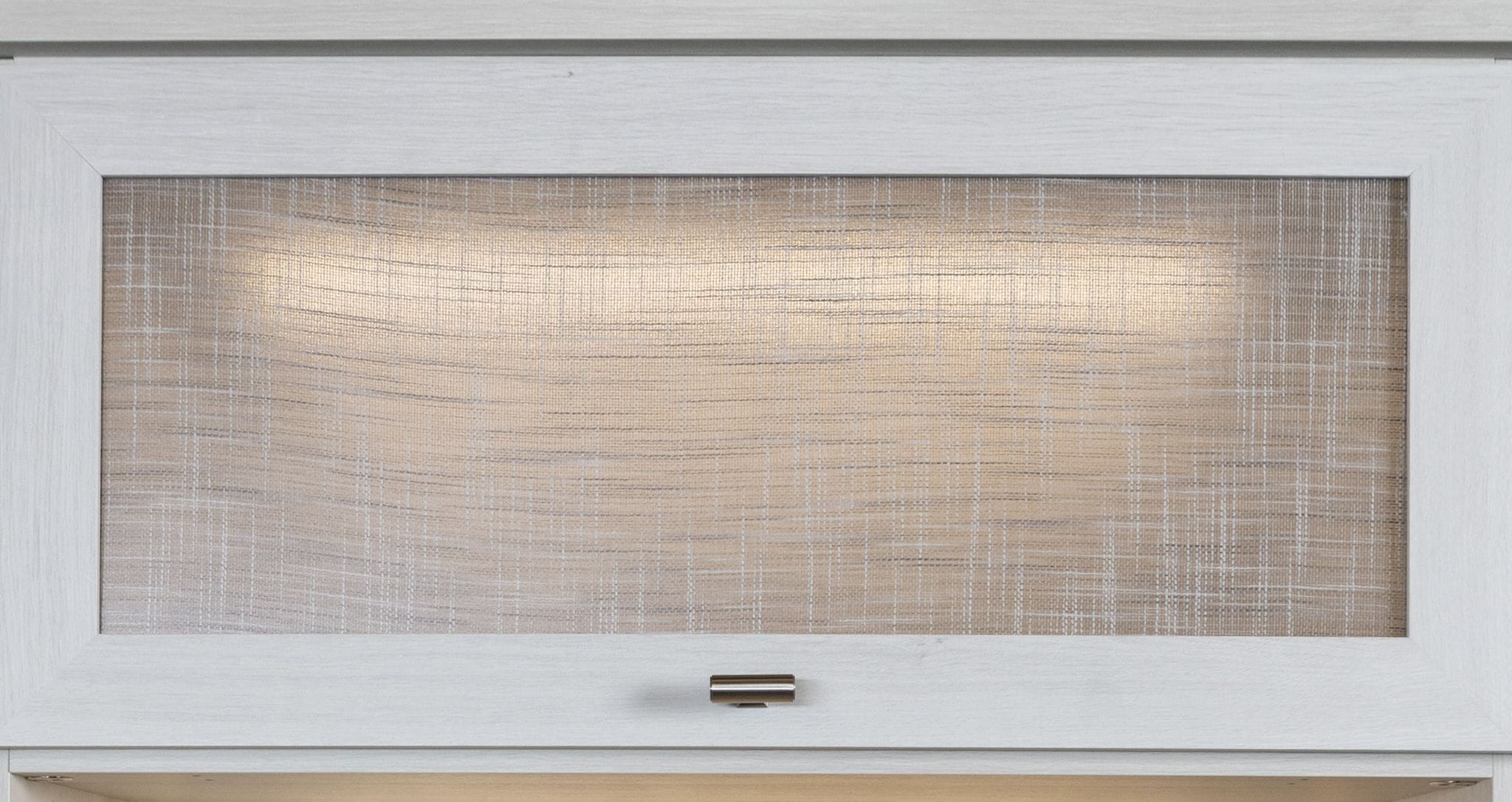 Custom cabinet doors designed with specialty panels created by California Closets