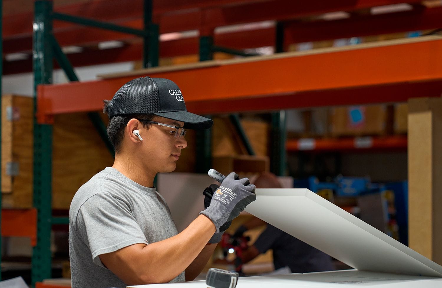 Worker at the Warehouse worker creating custom materials and finishes for California Closets