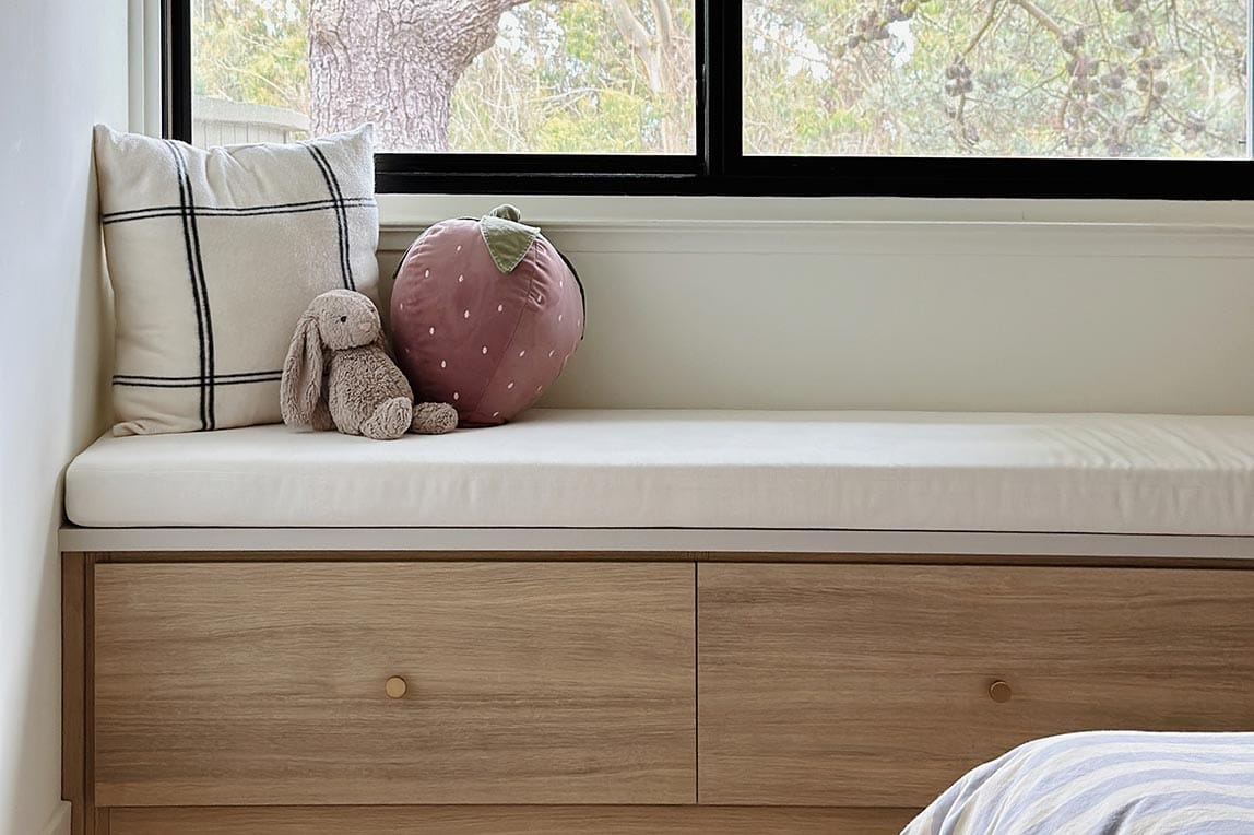 Customized entryway bench window seat with drawers below for storage space by California Closets