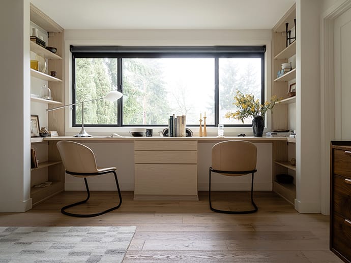 Coworking spaces with built in desks, drawers, shelving storage in a light finish by California Closets